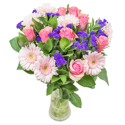 From the heart of Bromley, this bouquet tells a story of optimism and refined craftsmanship. Blush gerberas and classic pink roses intermingle gracefully, their petals blending in pastel harmony reminiscent of morning light over Bromley South. Spikes of rich purple statice dance among the blooms, offering delightful punctuation and a fresh, tactile quality-like the first burst of colour in a spring garden. Lush green foliage anchors the composition, infusing a touch of dewy vibrancy and calm. The graceful arcs of each stem and the fluid arrangement bring a sense of lightness, capturing the breezy atmosphere of a weekend stroll through Norman Park. Set in a simple glass vase, the colours glow with a tranquil softness, inviting closer admiration. Whether given as a cheerful get-well gesture or to brighten a sunlit Bromley kitchen, the bouquet's precise construction and joyful energy reflect the care unique to Flowers Bromley and the local community.